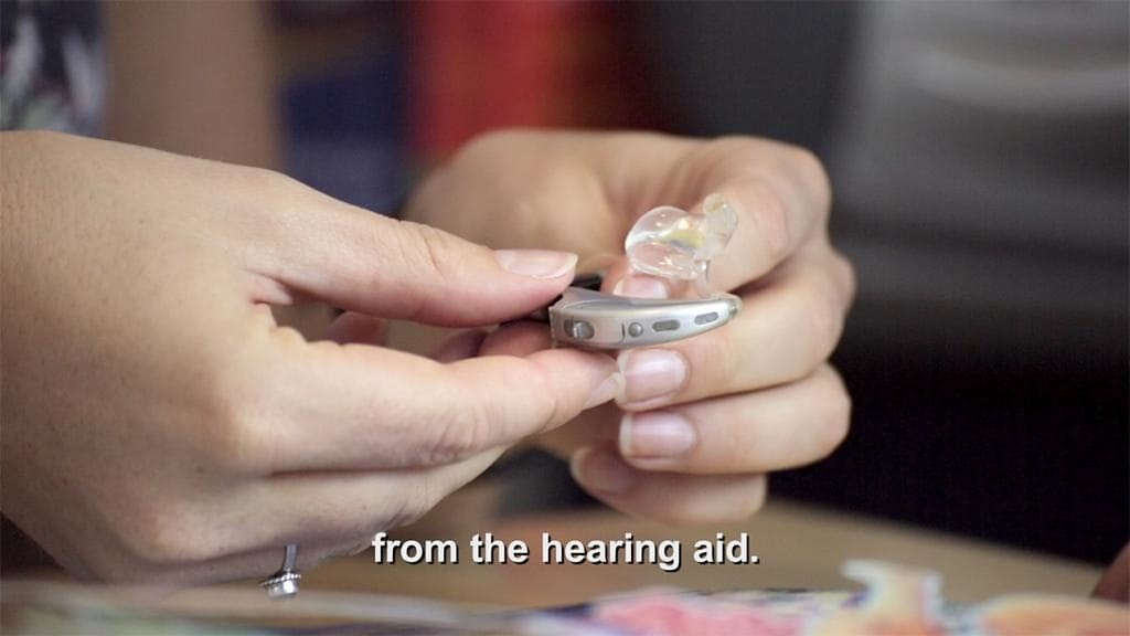 Innovative Training Videos for Eduplex Training Institute Close-up of battery being taken out of hearing aid