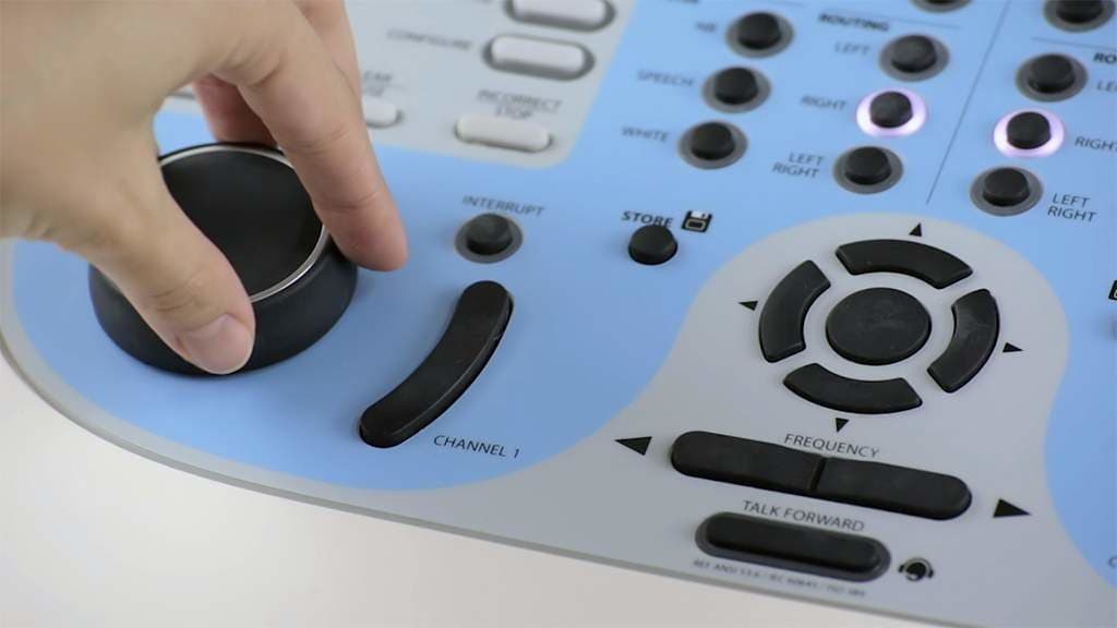 Innovative Training Videos for Eduplex Training Institute Close up of a hearing testing machine with a person's hand turning the buttons